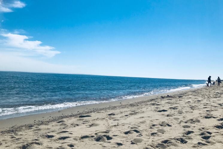 Sandy beach with light rolling waves