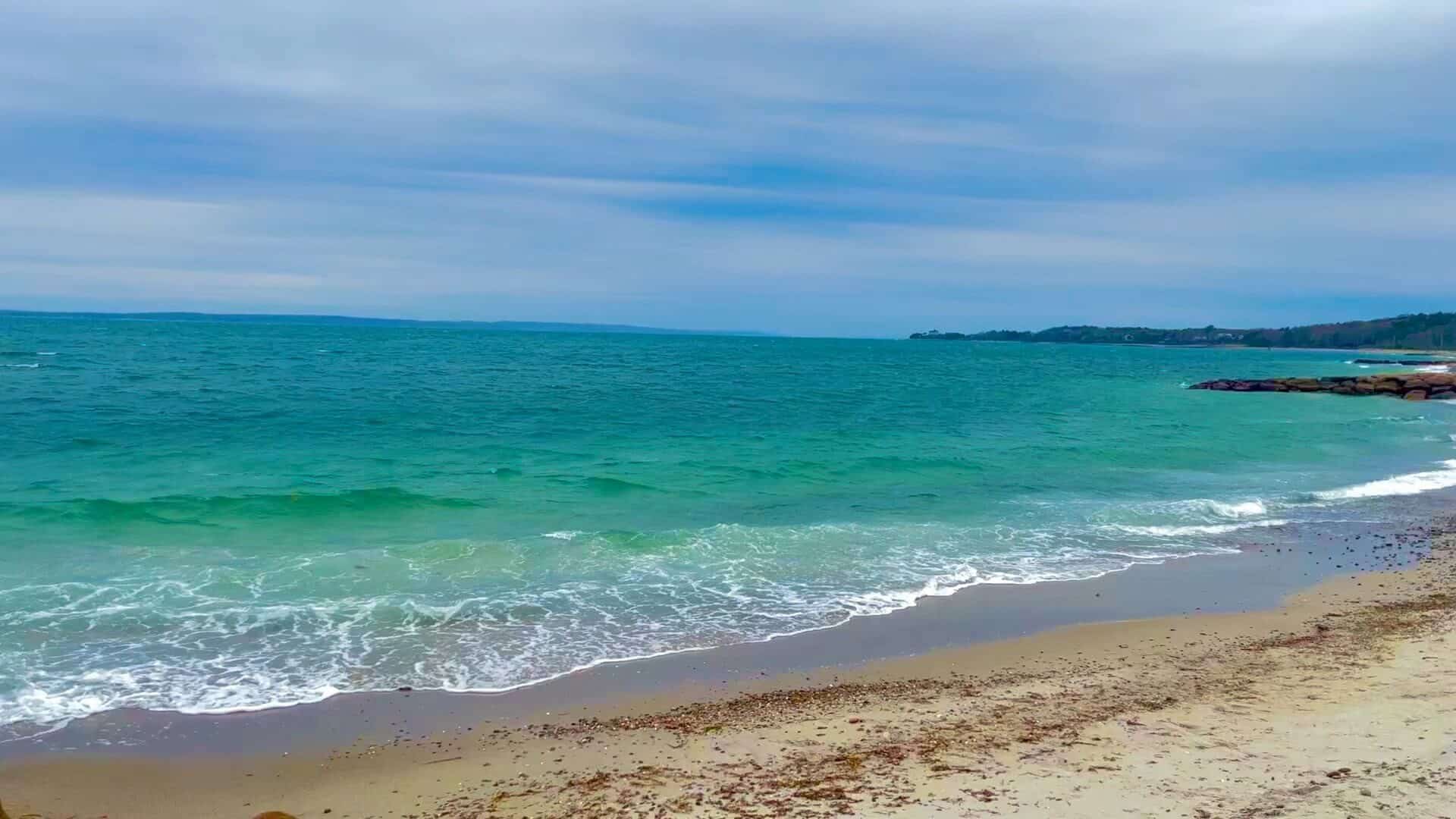 Sandy beach with light rolling waves